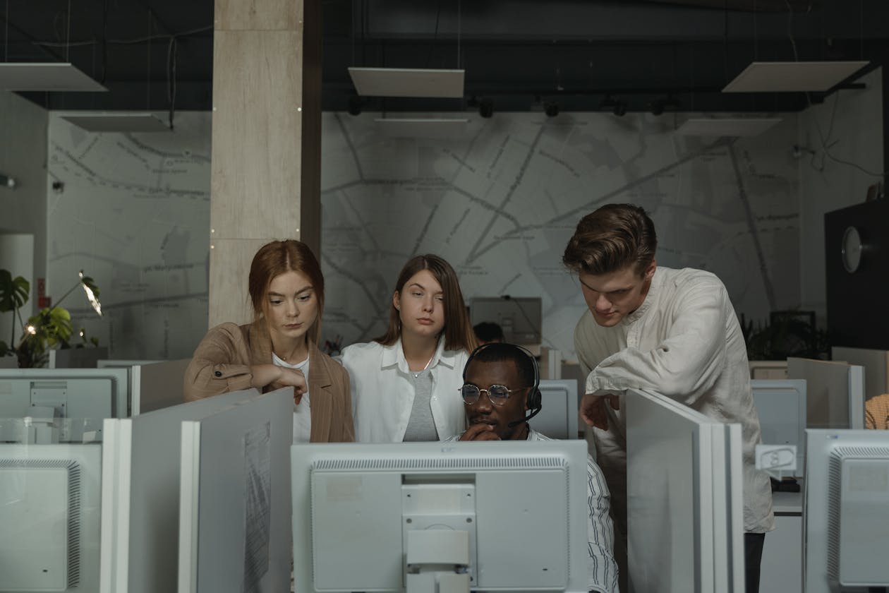 Team of developers working on computers in a tech office